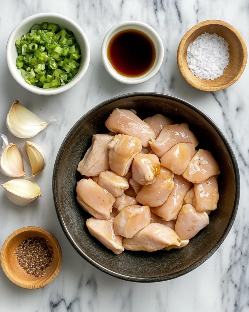 Crispy, golden-brown chicken bites coated in a sticky, smoky honey garlic glaze, garnished with sesame seeds and fresh parsley.