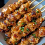 Juicy Bang Bang Chicken Skewers grilled to perfection with a spicy, creamy sauce, served with fresh vegetables.